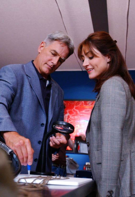 NCIS agents Gibbs and Kate Todd standing together, engaged in conversation.